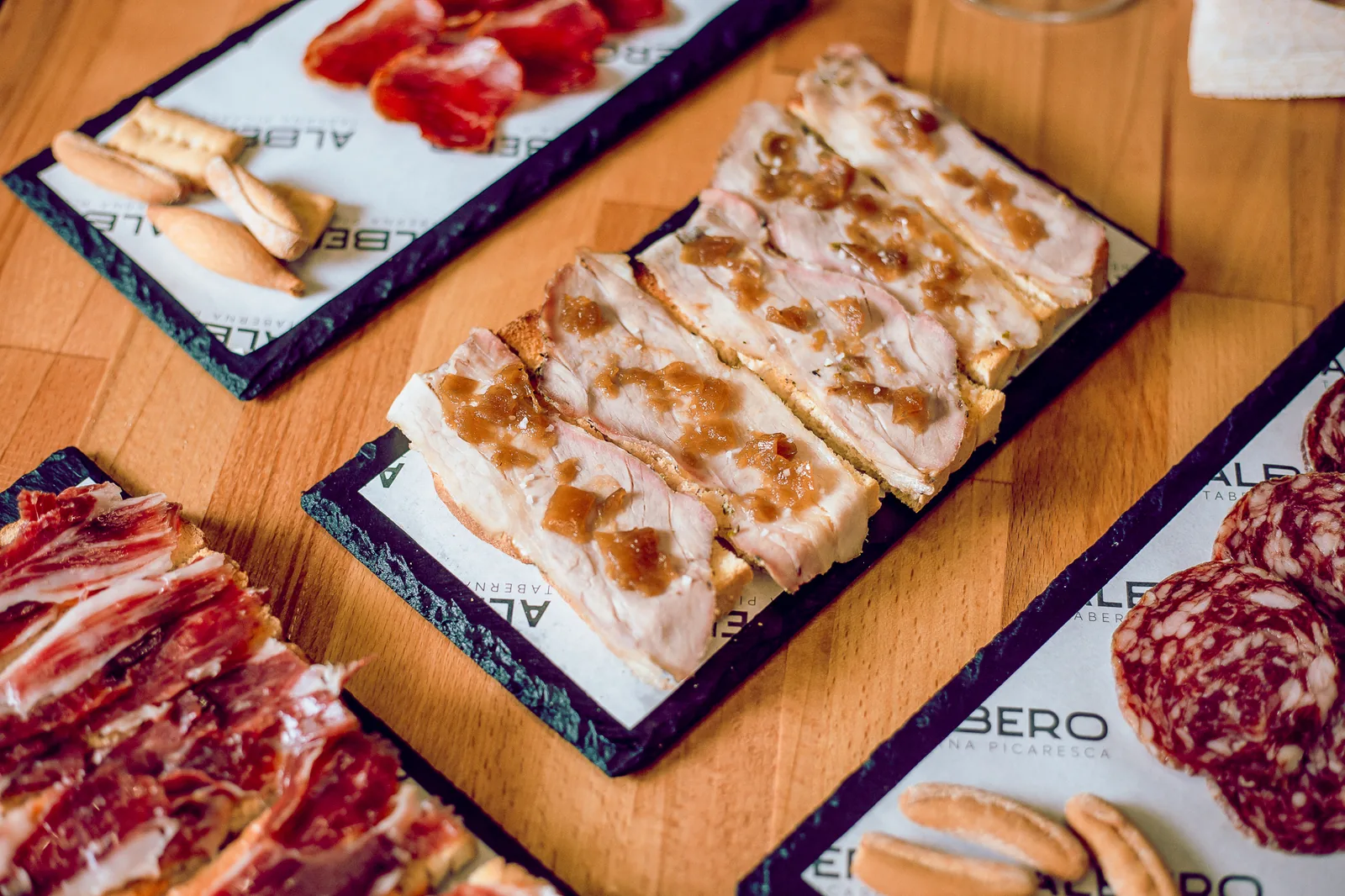 Tabla de ibéricos y quesos servida sobre pizarra Albero
